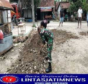 Berikan Rasa Aman Pengguna Jalan, Babinsa Bantu Warga Tambal Jalan Berlubang