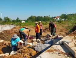Bersama Warga, Babinsa Gotong Royong Bangun Tanggul Penahan Banjir